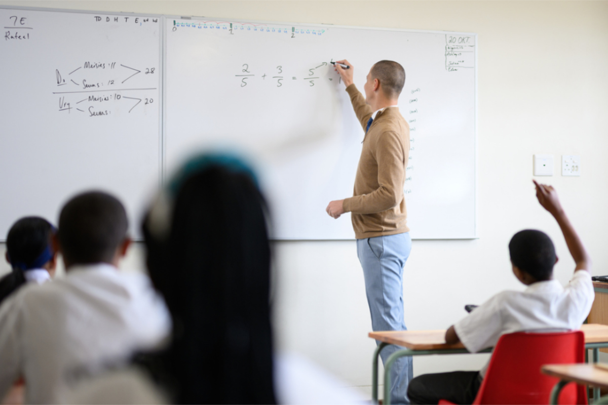 A teacher at the front of a classroom